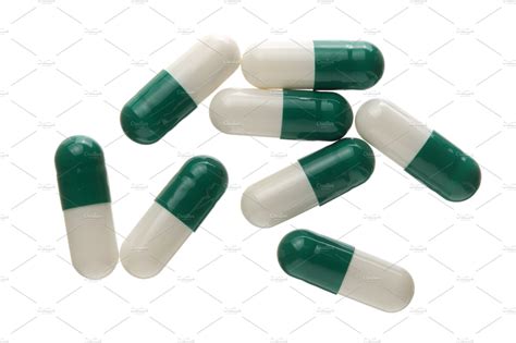 White And Green Pill Capsule Isolated On White Background Top View Flat