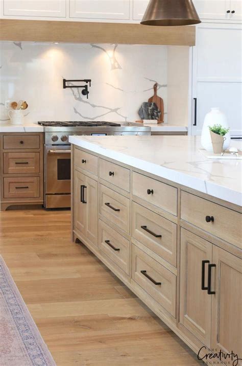 Open cabinets and bookshelves are a wonderful way to showcase the beauty of this natural material, and the use of white painted end panels and oak on the kitchen island. Beautiful transitional modern farmhouse kitchen with white ...