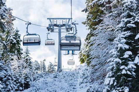 Snowy Ski Slopes And Chair Ski Lifts Station In Mountain Ski Resort