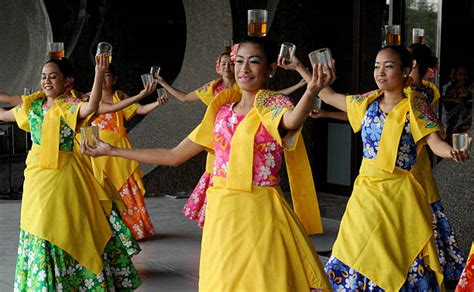 Filipino Dancers Perform The Binasuan A Dance Using Glasses With