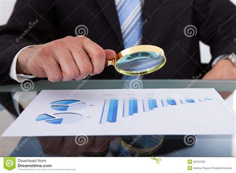 Businessman Analyzing Bar Graph Through Magnifying Glass Stock Photo ...