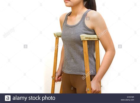 Woman Walking With Crutcheswalking Aid Stock Photo Alamy