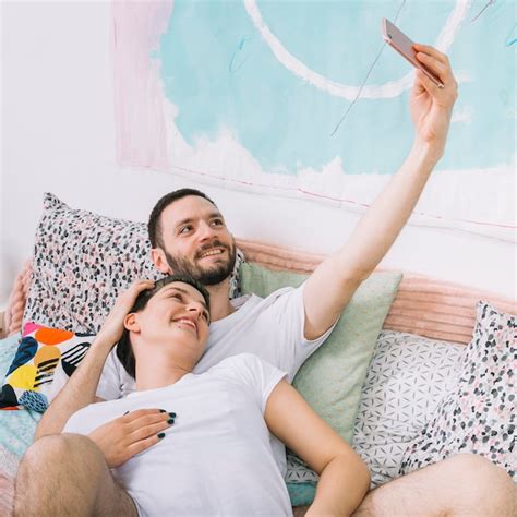 Free Photo Couple Taking Selfie In Bed