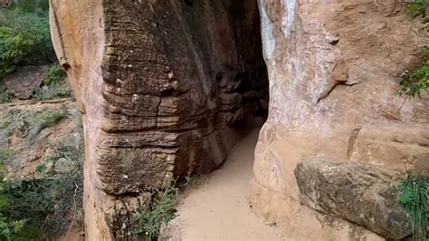 After a short hike up from the street, you go through a large natural cave. Zion National Park , walk through cave - YouTube