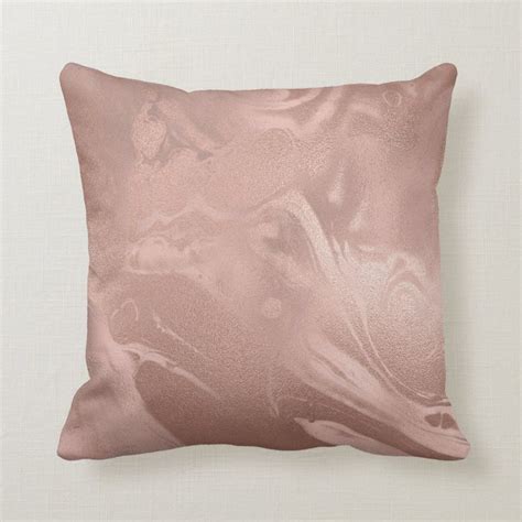 A Rose Gold Pillow With An Abstract Design