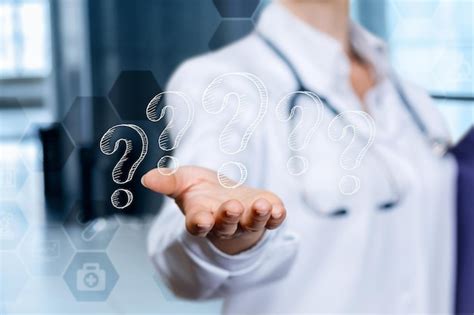 Premium Photo A Doctor Holds Out A Glass Screen With Question Marks