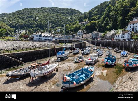 Lynmouth Village With Boats In The Harbour Rand The Tide Out A Bright
