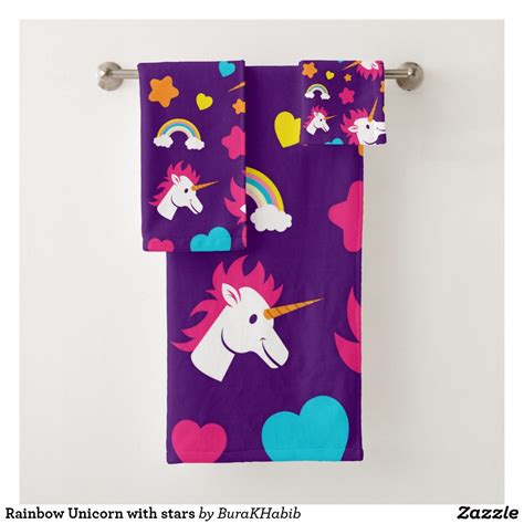 Two Purple Towels With Unicorns And Hearts On Them Hanging From A Towel