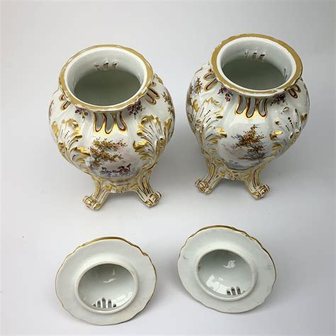 A Pair Of Continental Porcelain Vases And Covers Each Of Baluster Form Raised Upon Four Scroll