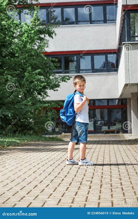 Adorable Boy Goes To School After Vacation A Schoolboy With A Backpack