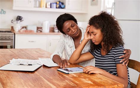 Mother Helps Stressed Teenage Daughter With Homework Anxiety