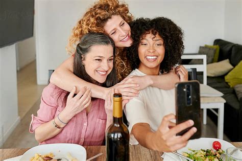 Friends Taking Selfies At Dinner By Stocksy Contributor Ivan Gener Stocksy