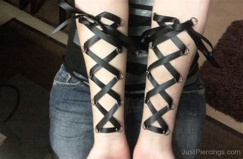 Corset Piercings With Black Ribbon On Arms