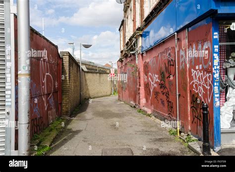 Graffiti And Tags Spray Painted Onto Walls Of An Alleyway Off Goldhawk