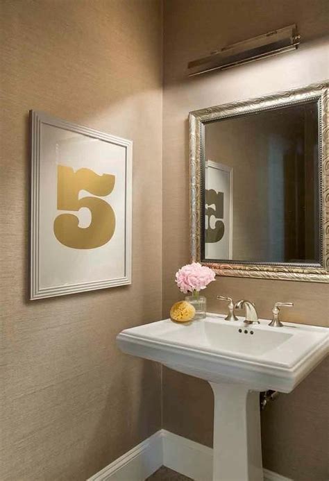 Chic Powder Room Boasts Walls Clad In Tan Grasscloth Lined With A