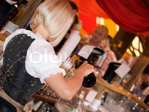 blond waitress pouring champagne stock image colourbox