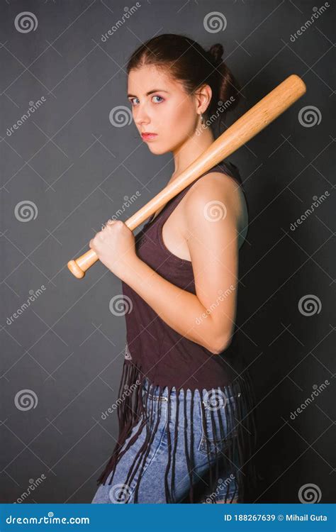 Young Beautiful Woman With A Baseball Bat In Her Hands Fashionable