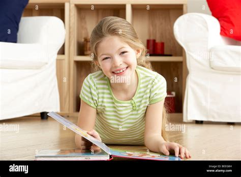 Young Girl Reading Book At Home Stock Photo Alamy