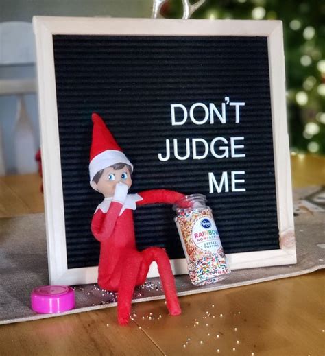 An Elf Is Sitting In Front Of A Sign That Says Dont Judge Me