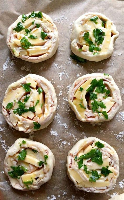6 uncooked puff pastry pinwheels with ham and cheese topped with chopped parsley puff pastry