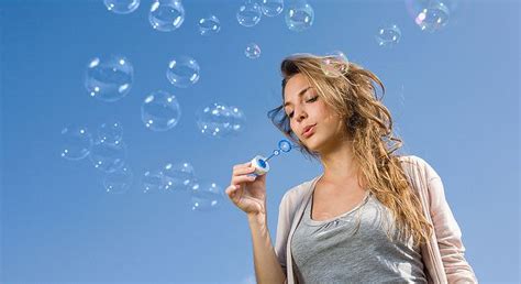 blowing bubbles into the sky blowing bubbles brunette girl bubbles