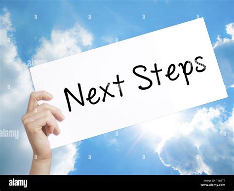 Next Steps Sign On White Paper Man Hand Holding Paper With Text