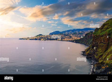 Sunset Over The City Of Funchal And Cliffs Of Madeira Island Stock