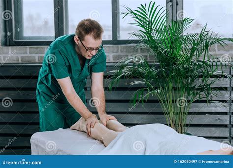 A Male Massage Therapist Massages The Feet Stock Image Image Of