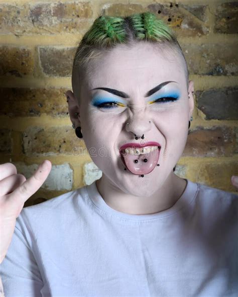Punk Girl With Green Hair Tongue And Nose Piercings Stock Photo Image