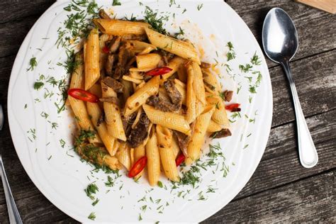 Delicious Penne Pasta With Beef On Rustic Wood Stock Photo Image Of