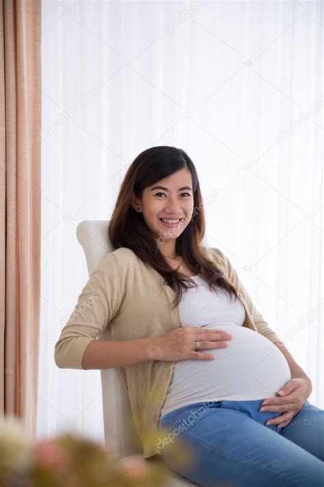 Happy Pregnant Asian Woman Touching Her Big Belly While
