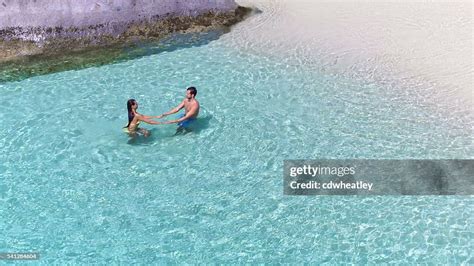 Attractive Couple Relaxing At A Tropical Beach High Res Stock Photo