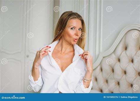 Flirting Charming Blonde Woman With Long Fair Hair In Casual Clothing