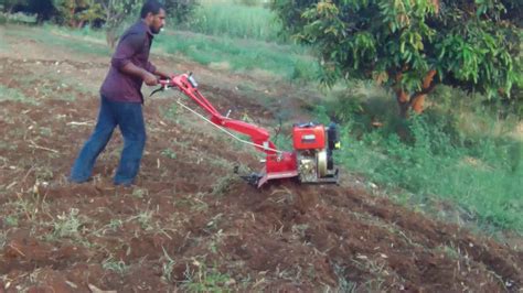 Operating Power Tiller Machine And Rotavator Working Tilling The Dry