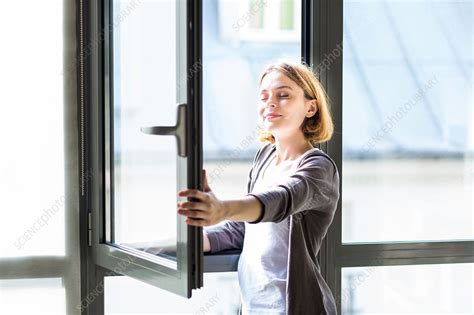 Woman Opening Window Stock Image C0352747 Science Photo Library