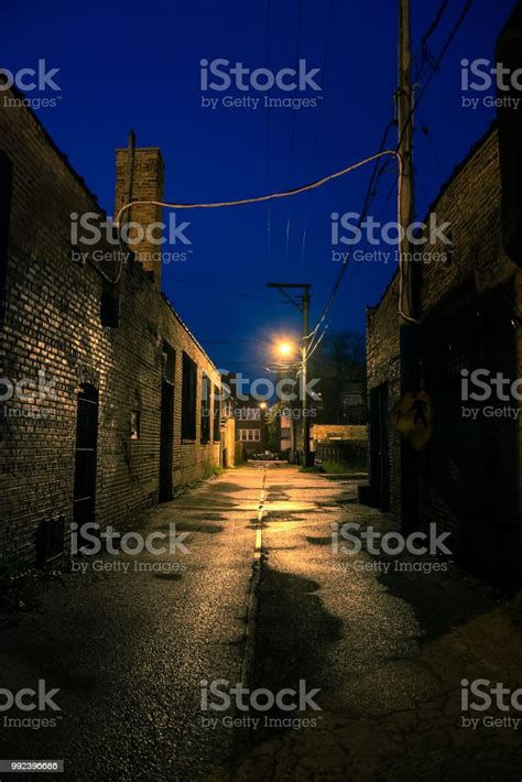 Dark Gritty And Wet Industrial City Alley At Night After Rain Stock