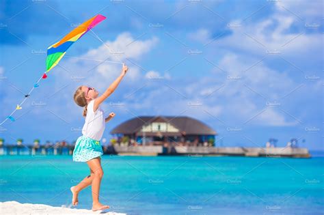 Little Cute Girl Playing With Flying Kite On Tropical Beach High