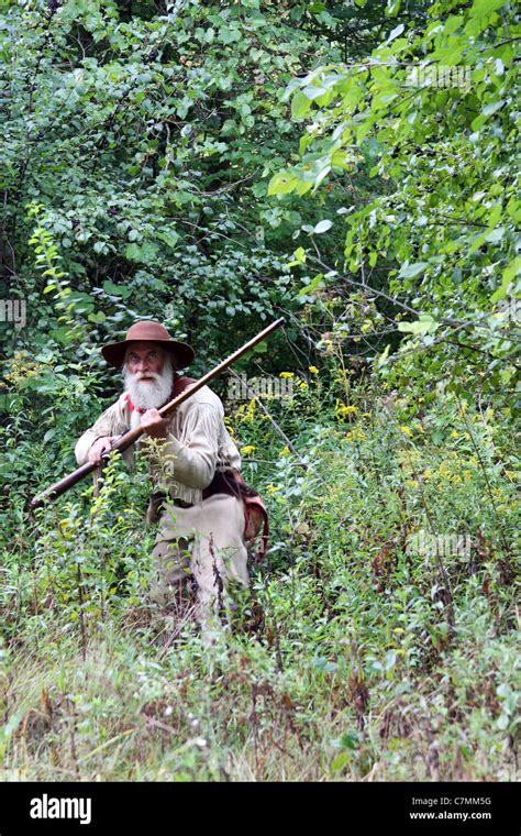 An Early American Hunter Hunting In The Woods Stock Photo Royalty Free