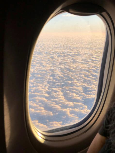 Fluffy Clouds Though Airplane Window During Flight · Free Stock Photo
