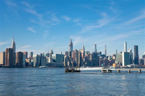 Midtown Manhattan Skyline Along The East River With A Ferry Boat Stop