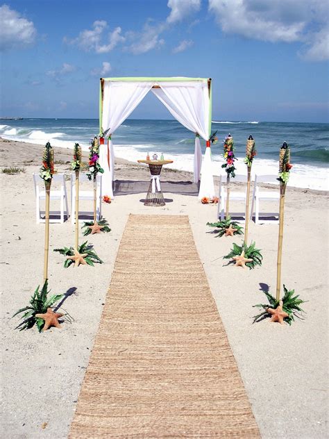 When wedding guests arrived at pink sands beach for the ceremony, they were met with a coconut, lime, and gin concoction called sky juice served in coconuts. Love is a Beach Wedding.com | Beach Wedding Packages