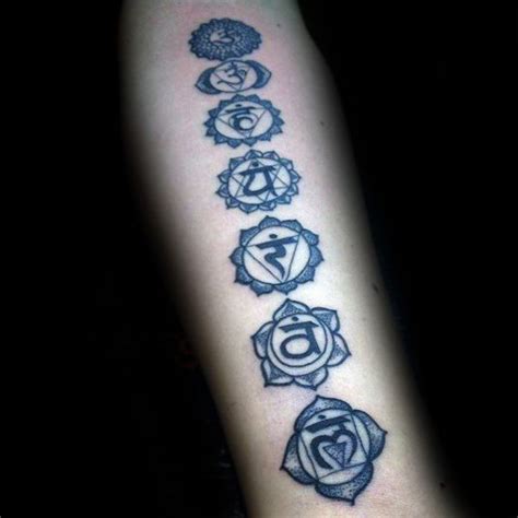 A Person With A Tattoo On Their Arm That Has Seven Chakras In It
