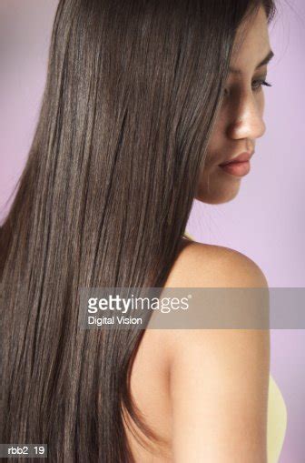 A Young Attractive Ethnic Girl With Beautiful Long Dark Hair Looks Down