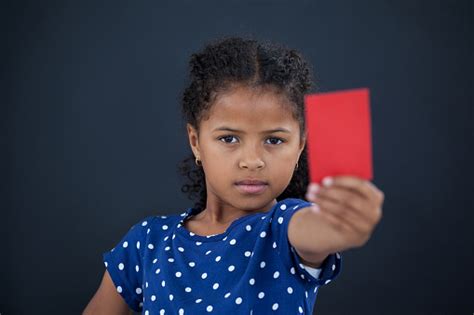 Close Up Portrait Of Girl Showing Red Card Stock Photo Download Image