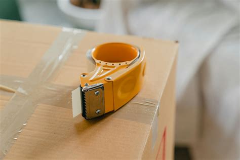 Packing Tape Gun On Carton Box · Free Stock Photo