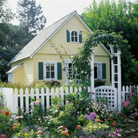 Little Yellow Cottagehouse With A White Picket Fence To Grow Roses On