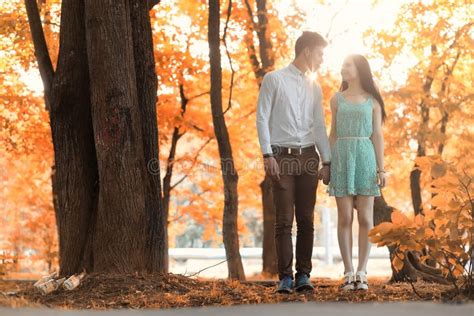Young Couple On A Walk In Autumn Park Stock Image Image Of Lifestyle