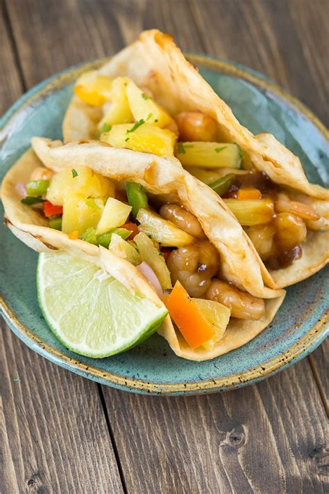 You get deliciously seasoned, tender and flaky fish pieces layered over hearty corn tortillas along with the best tacos toppings, and it's all finished with a rich and creamy fish tacos sauce. Teriyaki Shrimp Tacos - Garnished Plate