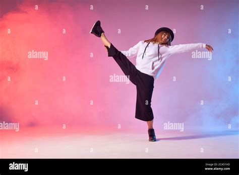 Flexible Young Dancer Doing Split Leap In The Air Raising Leg