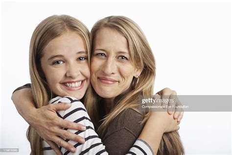 Close Up Of Smiling Mother And Daughter Hugging High Res Stock Photo